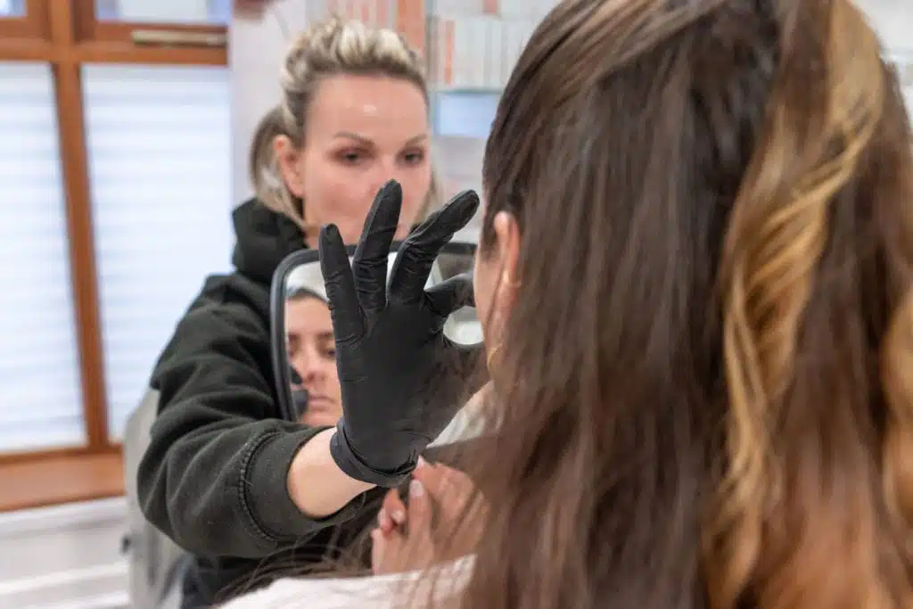 Demonstrating to the patient how it is important to look at proportions of the face, even when having lip filler.